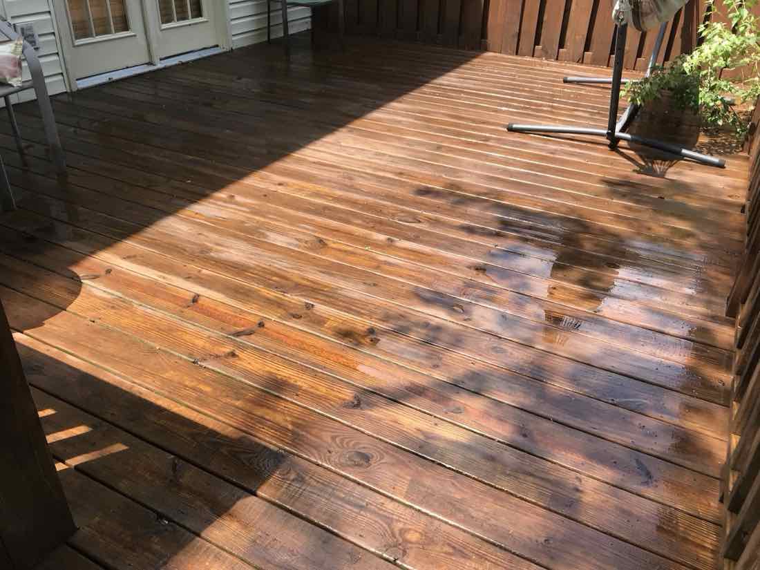 Same deck restored to rich wood color after cleaning